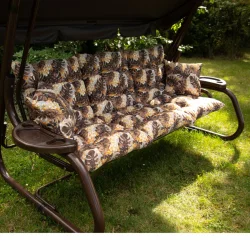 Huśtawka ogrodowa z poduszkami w liście, brązowo-żółta kolorystyka. Siedzisko i oparcie w jednym wzorze, przeznaczenie do ogrodu.