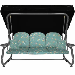 Huśtawka ogrodowa z daszkiem, idealna na taras. Turkusowe siedzisko z kwiatowym wzorem. Całość widoczna na zdjęciu.