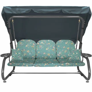 Huśtawka ogrodowa z daszkiem, przeznaczona do ogrodu. Tapicerka w kwiatowy wzór na zielonym tle.